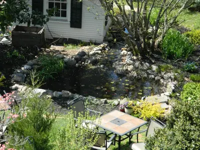 a small pond in the backyard of a house with a table in it at EJ Bowman House Bed & Breakfast in Lancaster