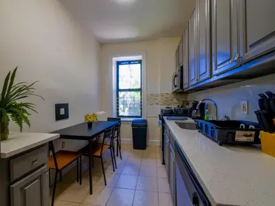 a kitchen with a sink and a counter top at Charming 1BR Apartment Near NYC Ideal for Urban Explorers in Jersey City