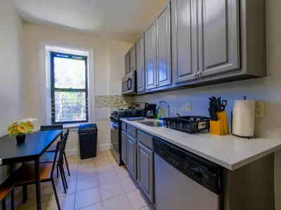a kitchen with a sink and a counter top at Charming 1BR Apartment Near NYC Ideal for Urban Explorers in Jersey City