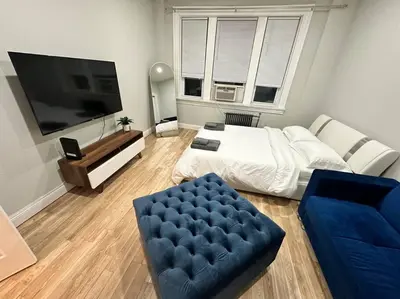 a large living room with a bed and a couch at Cozy 3 BR suite, 15 min to NYC &Times Sq in North Bergen