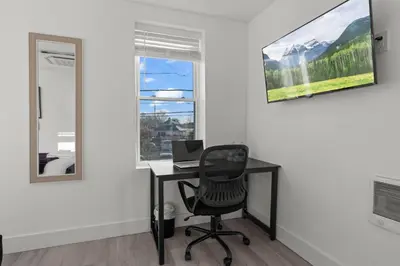 an office with a desk and a laptop on a wall at New Season Royals, Airport West in Chester