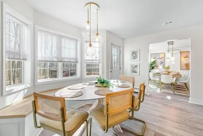 a kitchen and dining room with a table and chairs at Boho Haven Hideaway - Walk to Pool,Theater,Arcades, Firepit, Lake Access in Thornhurst