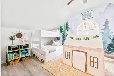 a childs bedroom with a bunk bed and a tree mural at Boho Haven Hideaway - Walk to Pool,Theater,Arcades, Firepit, Lake Access in Thornhurst