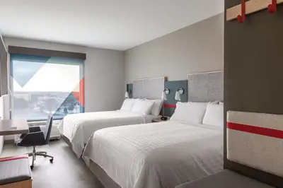 a hotel room with two beds and a window at avid hotel Harrisburg NE - Hershey Area by IHG in Harrisburg