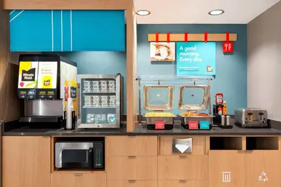 a kitchen with a counter with microwaves and appliances at avid hotel Harrisburg NE - Hershey Area by IHG in Harrisburg