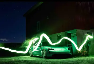a green car with lights on the side of a house at Idea Farm in Callicoon Center