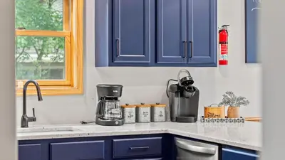a kitchen counter with blue cabinets and a blender at Bluejay Getaway by AvantStay Private Lake Cabin • Hot Tub Game Room Walk to Lake in Albrightsville