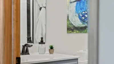 a bathroom sink with a bottle of soap and a potted plant at Bluejay Getaway by AvantStay Private Lake Cabin • Hot Tub Game Room Walk to Lake in Albrightsville