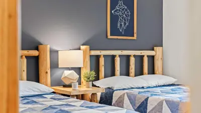 two beds sitting next to each other in a bedroom at Bluejay Getaway by AvantStay Private Lake Cabin • Hot Tub Game Room Walk to Lake in Albrightsville