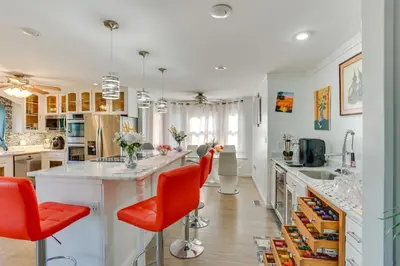 a kitchen with red chairs and a large island at Harrisburg Retreat with 8 Mi to Hersheypark in Harrisburg
