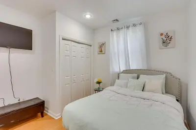 a bedroom with a large bed and a television at Harrisburg Retreat with 8 Mi to Hersheypark in Harrisburg