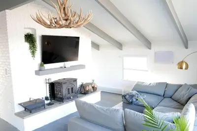 a living room with a blue couch and a tv at 10 guest Ski Chalet Pools Golf Ski Hike in Vernon Township