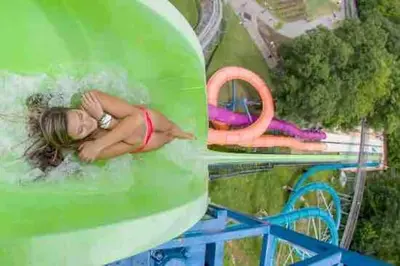 a picture of a woman on a water slide at 10 guest Ski Chalet Pools Golf Ski Hike in Vernon Township