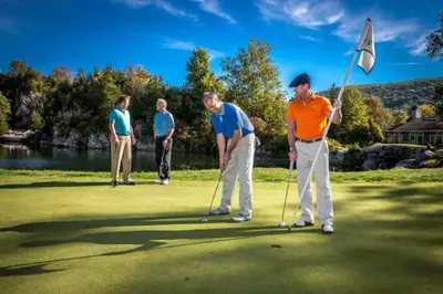 a group of men playing golf on a golf course at 10 guest Ski Chalet Pools Golf Ski Hike in Vernon Township