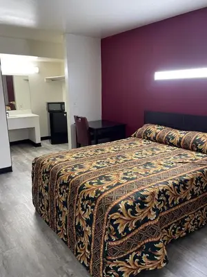 a hotel room with a bed and a table at Budget Inn - Elizabeth, NJ in Elizabeth