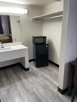 a bathroom with a sink and a black refrigerator at Budget Inn - Elizabeth, NJ in Elizabeth