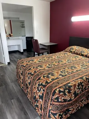 a hotel room with a bed and a desk at Budget Inn - Elizabeth, NJ in Elizabeth