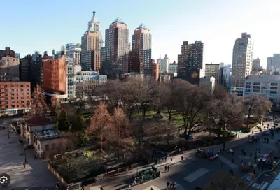 a view of a city with people walking in a park at Tranquil Haven 1-Bdr Apt in Downtown Manhattan's Union Square in New York