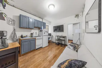 a living room with a couch and a kitchen at Tranquil Haven 1-Bdr Apt in Downtown Manhattan's Union Square in New York