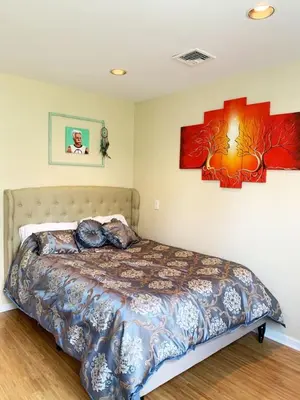 a bedroom with a bed and two pictures on the wall at MASSiVE Bohemian Oasis in Philly 5 Bdrm Sleeps 12 in Philadelphia