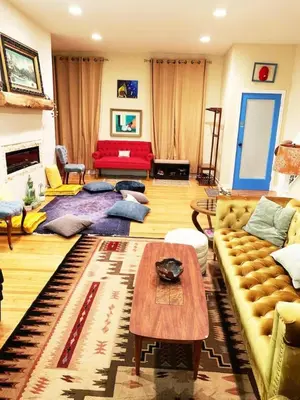 a living room with a couch and a table at MASSiVE Bohemian Oasis in Philly 5 Bdrm Sleeps 12 in Philadelphia