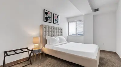 a white bedroom with a large bed and a window at PP 1009 Beautiful Corporate 2br Apt, Pool in Harrisburg