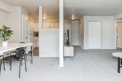 a kitchen and dining room with a table and chairs at Spacious Retreat I Balcony I Parking I Chateau in Wilmington