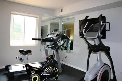 a room with a treadmill and an exercise bike at Spacious Retreat I Balcony I Parking I Chateau in Wilmington