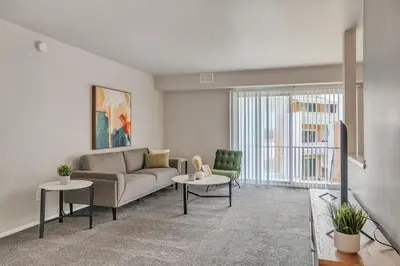a living room with a couch and two chairs at Spacious Retreat I Balcony I Parking I Chateau in Wilmington