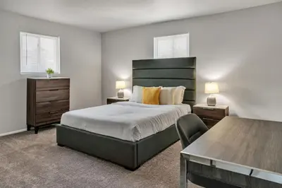 a bedroom with a large bed and a table at Luxurious 2-bedroom Apartment In Wilmington in Wilmington