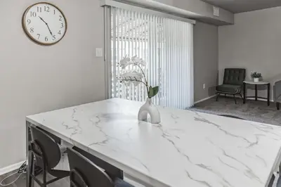 a white marble table with a vase of flowers on it at Luxurious 2-bedroom Apartment In Wilmington in Wilmington
