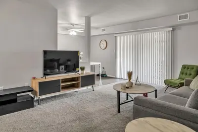 a living room with a couch and a tv at Luxurious 2-bedroom Apartment In Wilmington in Wilmington