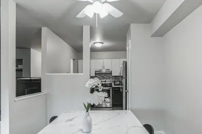 a kitchen with a table with a vase of flowers on it at Luxurious 2-bedroom Apartment In Wilmington in Wilmington