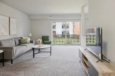 a living room with a couch and a table at Historic Charm Meets Modern Comfort The Chateau in Wilmington