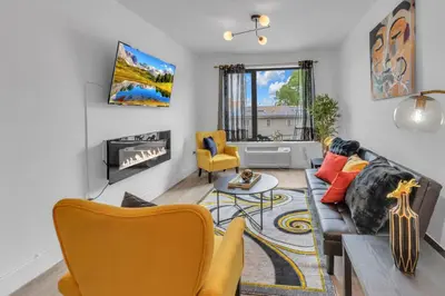 a living room with a couch and a fireplace at Royal Oasis Indoor Pool, FREE Parking, Near NYC in Elizabeth