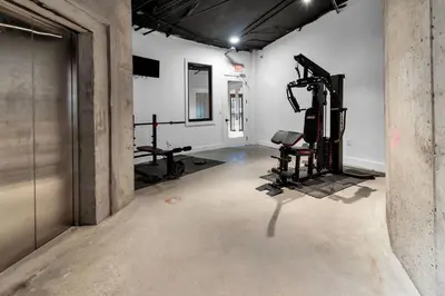 an empty room with a gym with two tread machines at Royal Oasis Indoor Pool, FREE Parking, Near NYC in Elizabeth