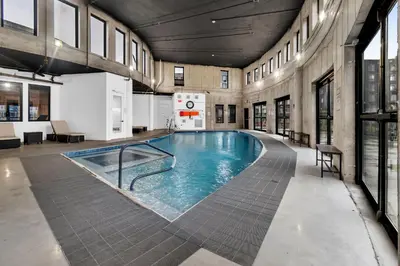 a large swimming pool in a building at Royal Oasis Indoor Pool, FREE Parking, Near NYC in Elizabeth