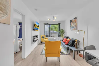 a living room with a couch and a table at Royal Oasis Indoor Pool, FREE Parking, Near NYC in Elizabeth