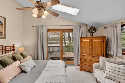 a bedroom with a bed and a ceiling fan at Lakefront Family Home, Kayaks, Hot Tub, Fireplace in Lake Ariel