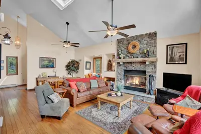 a living room with couches and a fireplace at Lakefront Family Home, Kayaks, Hot Tub, Fireplace in Lake Ariel