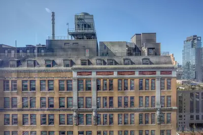 an old building in the middle of the city at Blueground Hudson Yards gym rock wall arcade NYC-1453 in New York