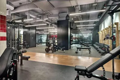 a gym with a lot of exercise equipment in it at Blueground Hudson Yards gym rock wall arcade NYC-1453 in New York