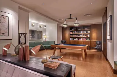 a living room with a pool table in it at Blueground Hudson Yards gym rock wall arcade NYC-1453 in New York