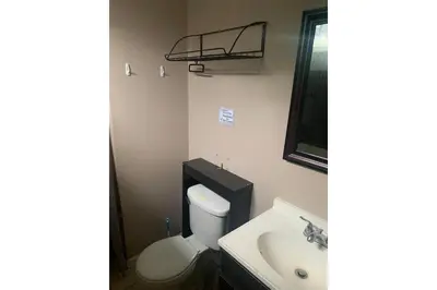 a bathroom with a toilet and a sink at Werry's Cottages and Pub By OYO East Stroudsborg - Weekly Stays in East Stroudsburg