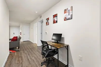 a room with a desk with a computer on it at Family & Traveler Haven - NYC & NWK w/free parking in Newark