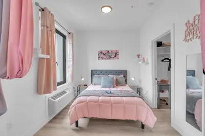 a pink bedroom with a pink bed and a mirror at Pink Heaven Indoor Pool, FREE Parking, Near NYC in Elizabeth