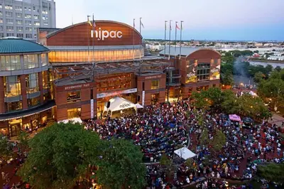 a large crowd of people in front of a building at Cozy Stylish retreat - NYC & NWK w free parking in Bayonne