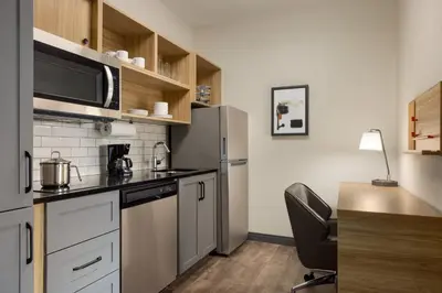 a kitchen with a stainless steel refrigerator and a microwave at Candlewood Suites Pittston by IHG in Pittston