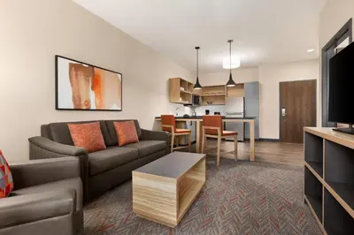 a living room with a couch and a table at Candlewood Suites Pittston by IHG in Pittston