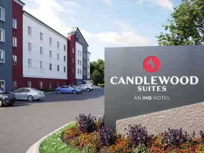 a sign in front of a building with cars parked at Candlewood Suites Pittston by IHG in Pittston